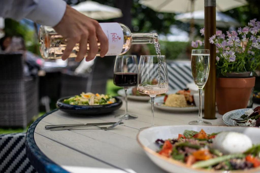 Wine being poured summer garden The Queens Hotel