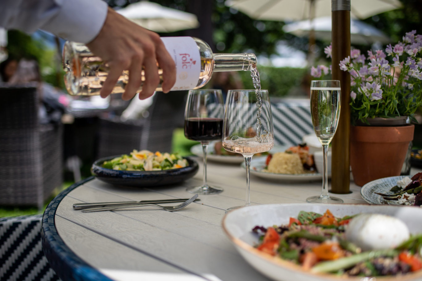 Wine being poured summer garden The Queens Hotel