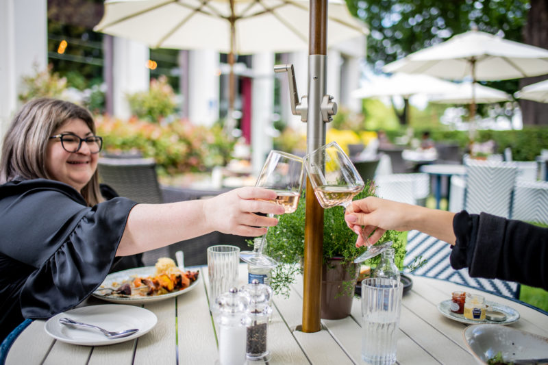 Glasses being clinked summer garden Queens Hotel