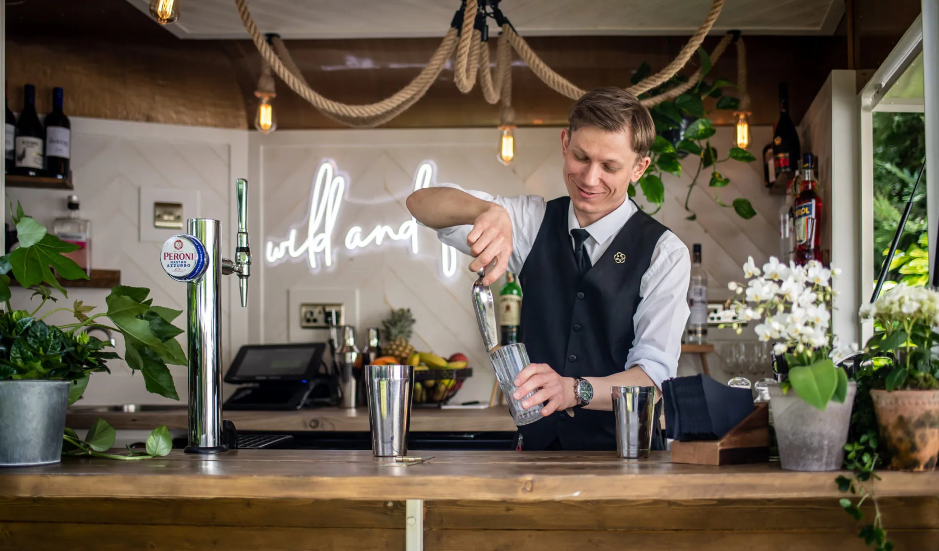 Cocktails being prepared summer garden horsebox bar