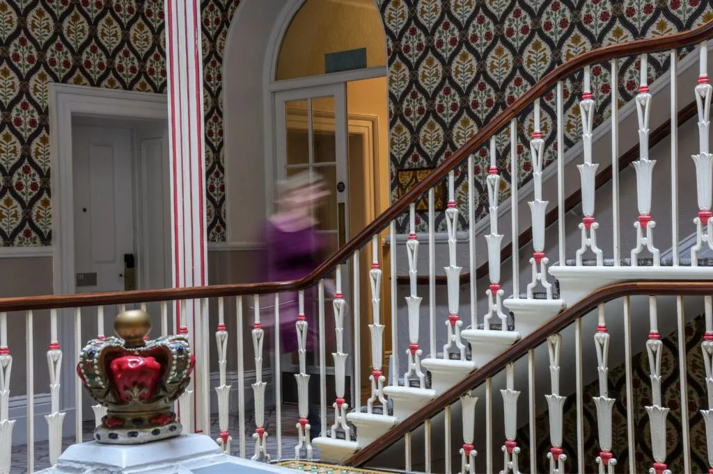 The Queens Hotel Cheltenham blurred guests going up the stairs