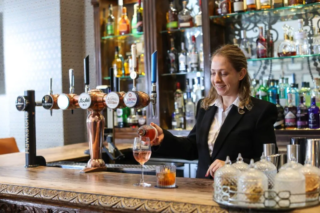 The Queens Hotel Cheltenham waitress pouring wine