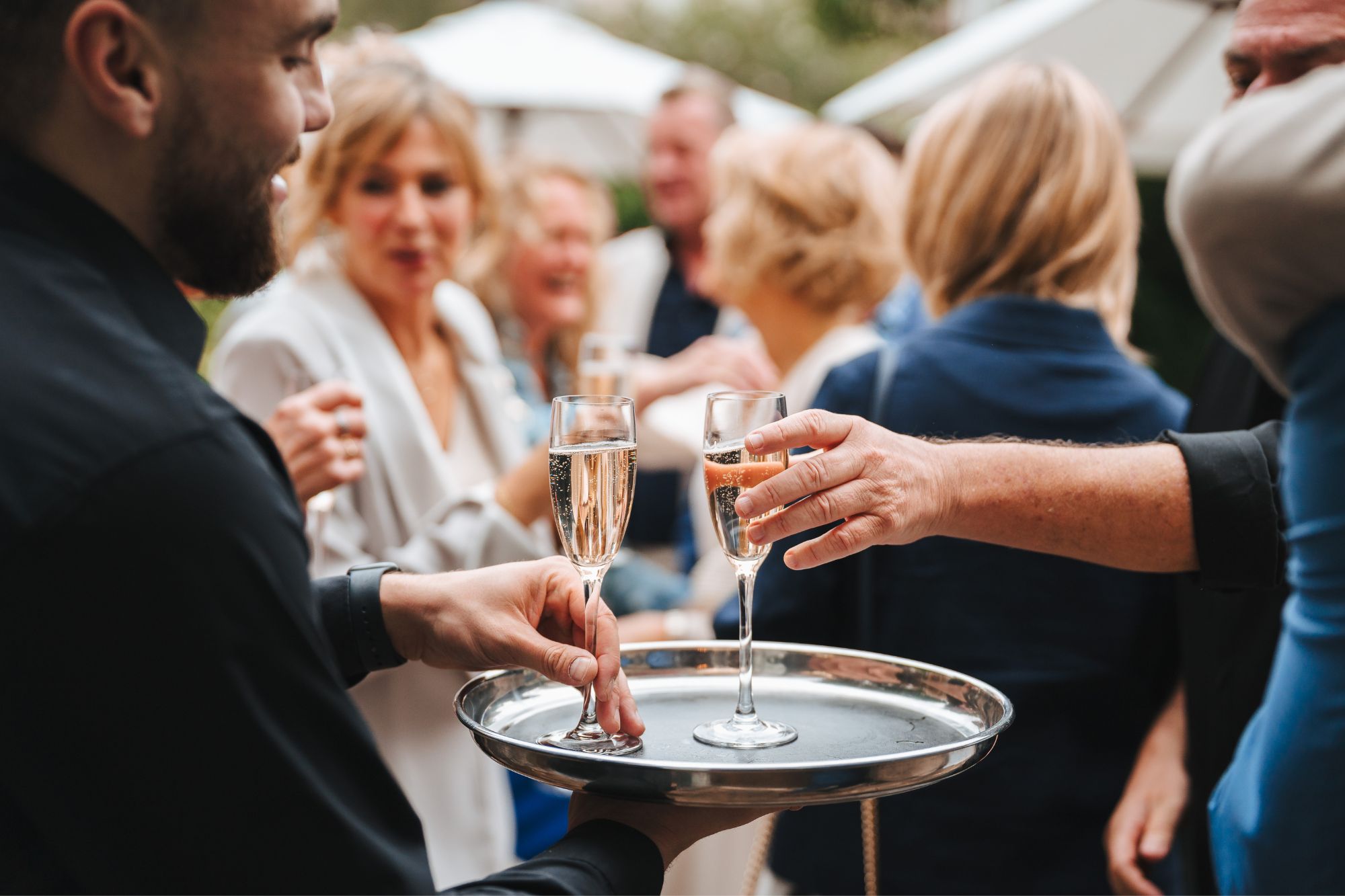 The Queens Hotel Cheltenham taking Prosecco from waiter in the garden